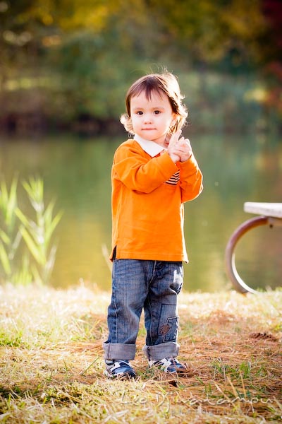 boy in orange shirt and jeans standing by pond. Commercial comp card photograper Kent Island Annapolis MD Washington DC