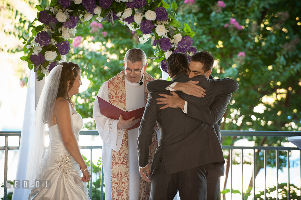 Groom hugging Bride's twin brother. Harbour View Events Woodbridge Virginia wedding ceremony and reception photo, by wedding photographers of Leo Dj Photography. http://leodjphoto.com