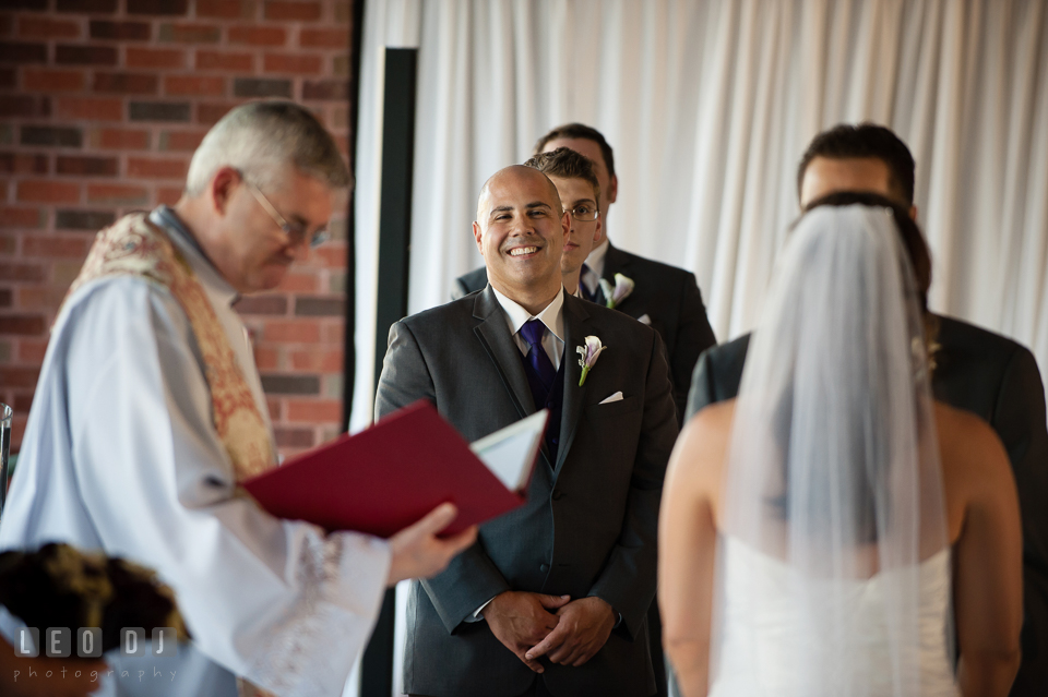 Best man smiling during wedding vow. Harbour View Events Woodbridge Virginia wedding ceremony and reception photo, by wedding photographers of Leo Dj Photography. http://leodjphoto.com