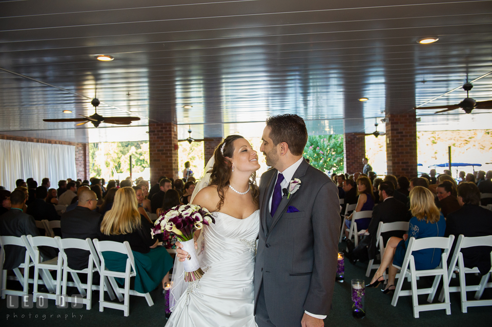 Bride and Groom kissing during the recessional. Harbour View Events Woodbridge Virginia wedding ceremony and reception photo, by wedding photographers of Leo Dj Photography. http://leodjphoto.com