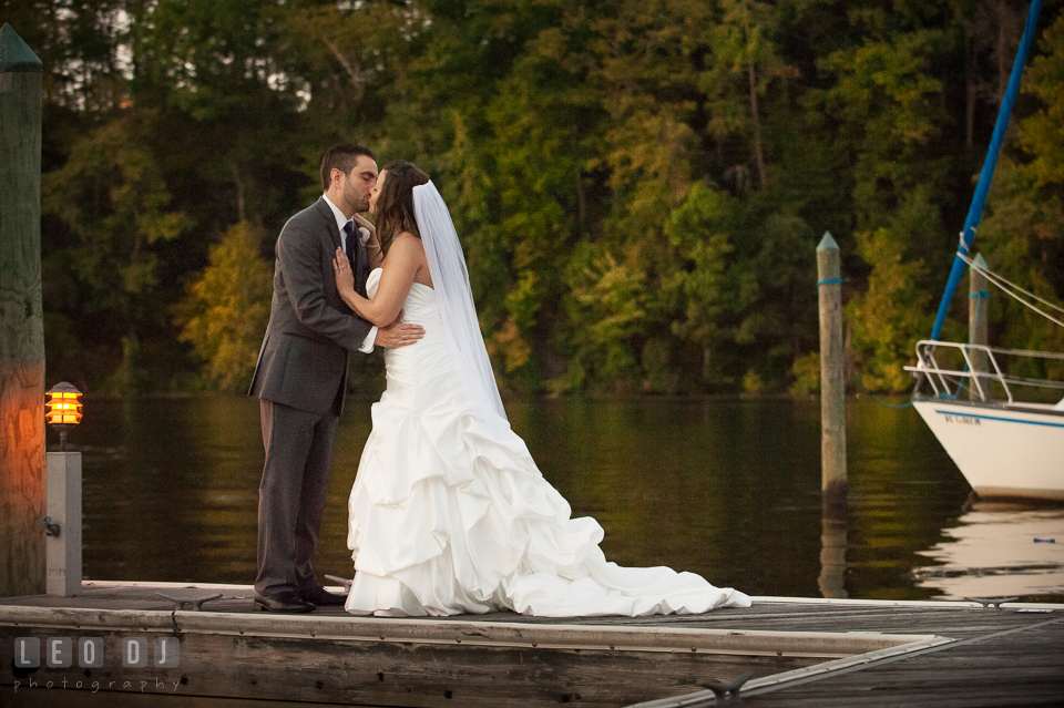 Groom kissing Bride by the dock. Harbour View Events Woodbridge Virginia wedding ceremony and reception photo, by wedding photographers of Leo Dj Photography. http://leodjphoto.com