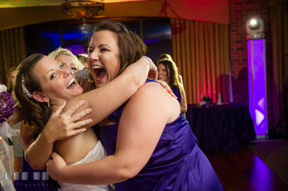 Bride hugging winner of the bouquet tossing. Harbour View Events Woodbridge Virginia wedding ceremony and reception photo, by wedding photographers of Leo Dj Photography. http://leodjphoto.com