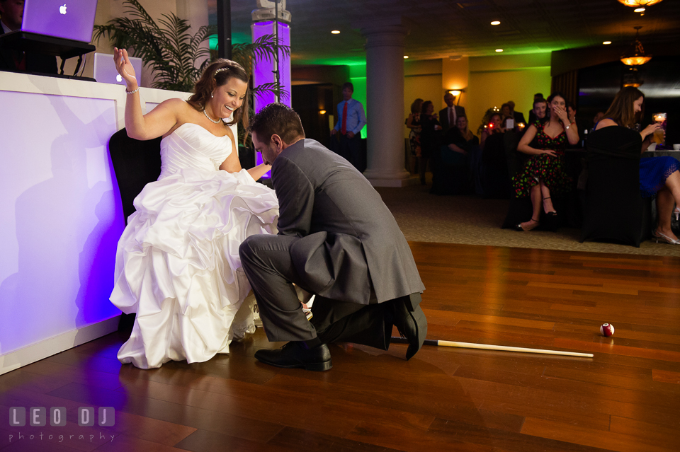 Groom looking for Bride's garter belt but found billiard balls and cue sticks instead. Harbour View Events Woodbridge Virginia wedding ceremony and reception photo, by wedding photographers of Leo Dj Photography. http://leodjphoto.com