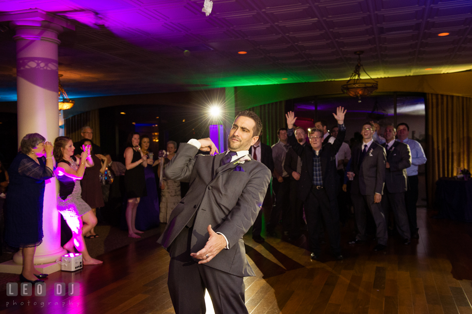 Groom tossing the garter. Harbour View Events Woodbridge Virginia wedding ceremony and reception photo, by wedding photographers of Leo Dj Photography. http://leodjphoto.com