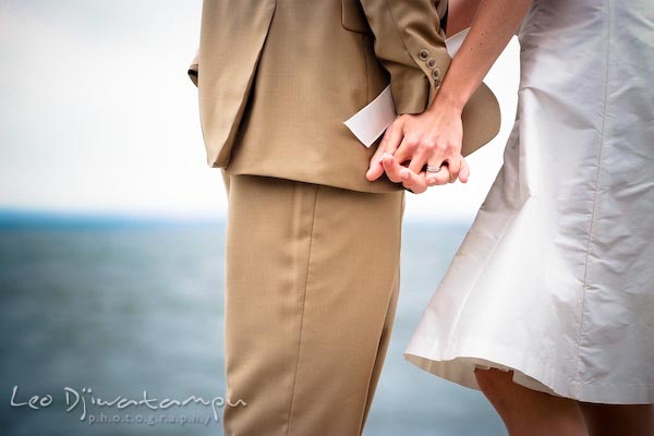 bride groom holding hands, by chesapeake bay beach. Annapolis Kent Island MD Modern Intimate Candid Posed Photojournalistic Style Wedding Photographer