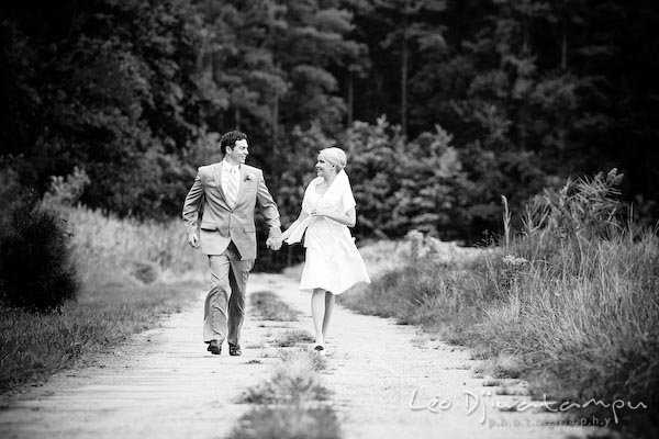 bride groom running on road path, forest behind. Annapolis Kent Island MD Modern Intimate Candid Posed Photojournalistic Style Wedding Photographer
