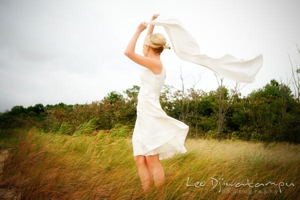 bride holding scarf in the air, wind blowing the trees and tall prairie grass. Annapolis Kent Island MD Modern Intimate Candid Posed Photojournalistic Style Wedding Photographer