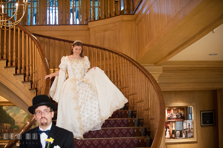 Bride quietly coming down the stairs excited to meet Groom. Baltimore Maryland Science Center wedding, getting ready photo at Royal Sonesta Harbor Court hotel, by wedding photographers of Leo Dj Photography. http://leodjphoto.com