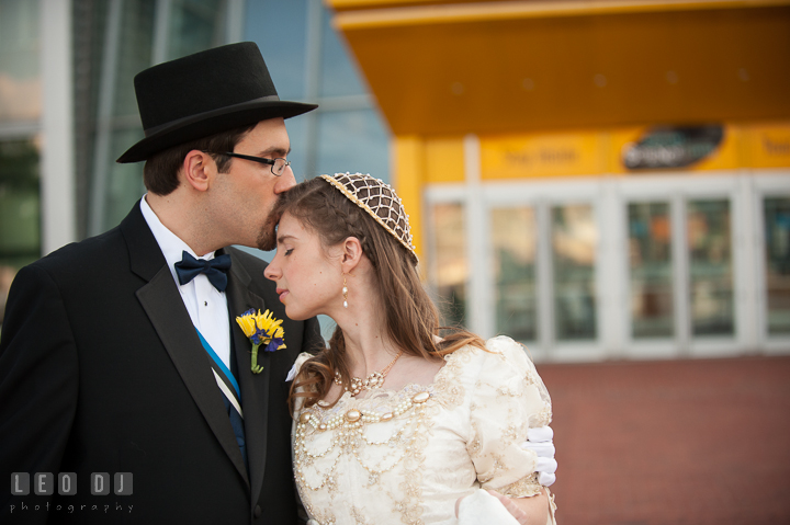 Groom kissing Bride on he forehead. Baltimore Maryland Science Center wedding reception and ceremony photo, by wedding photographers of Leo Dj Photography. http://leodjphoto.com