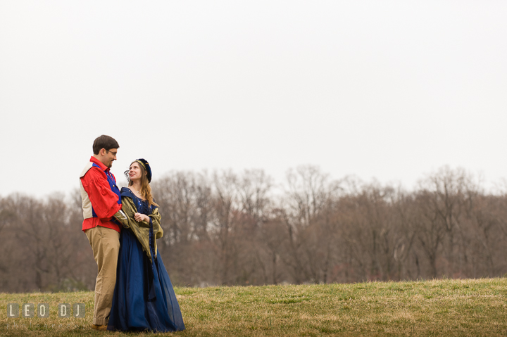 Engaged guy and his fiancée in a field. Renaissance Costume Cosplay fun theme pre-wedding engagement photo session at Maryland, by wedding photographers of Leo Dj Photography. http://leodjphoto.com