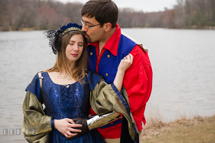 Engaged guy kissed his fiancée by a lake. Renaissance Costume Cosplay fun theme pre-wedding engagement photo session at Maryland, by wedding photographers of Leo Dj Photography. http://leodjphoto.com