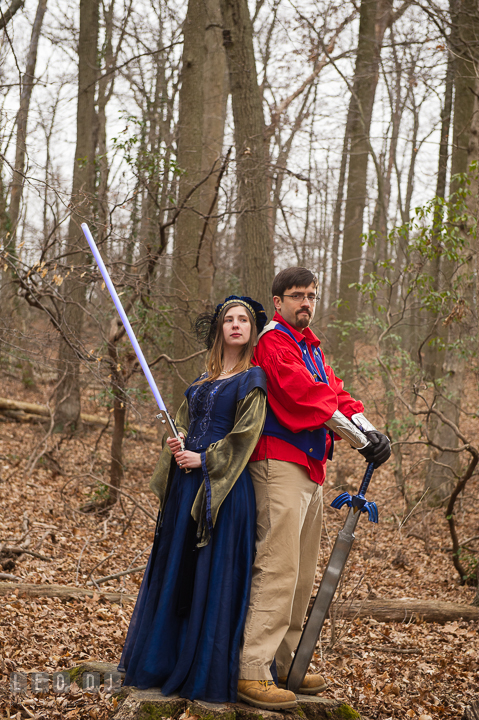 Engaged couple posing in the woods with their Zelda sword and light saber. Renaissance Costume Cosplay fun theme pre-wedding engagement photo session at Maryland, by wedding photographers of Leo Dj Photography. http://leodjphoto.com