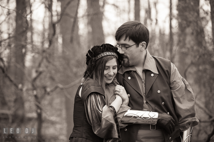 Engaged couple cuddling together and smiling. Renaissance Costume Cosplay fun theme pre-wedding engagement photo session at Maryland, by wedding photographers of Leo Dj Photography. http://leodjphoto.com