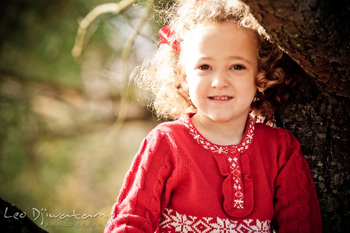 cute girl with curly hair, red ribon and red dress. Candid children photographer St Michael Tilghman Island MD