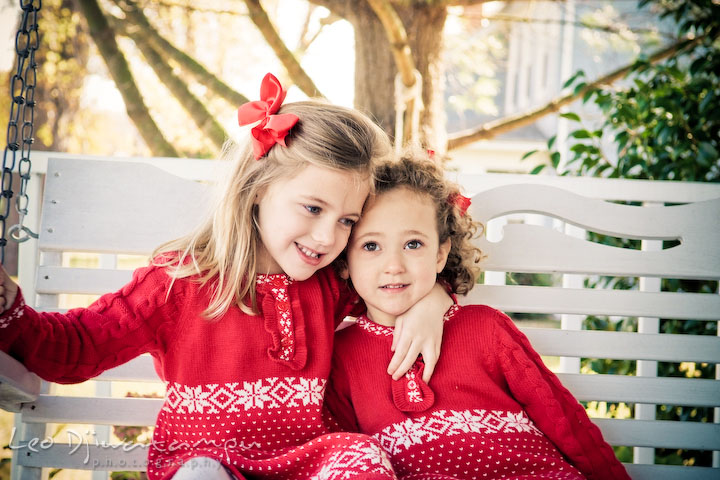 sisters hugging, smiling. Candid children photographer St Michael Tilghman Island MD