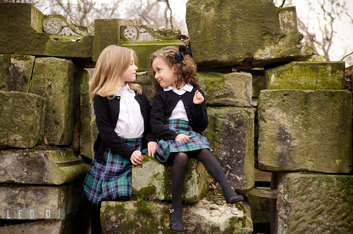 Two girls looking at each other. Washington DC fun and candid children lifestyle photo session of Helena and Vivian by photographers of Leo Dj Photography.