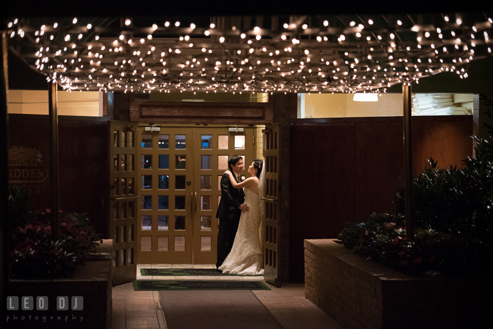 Hidden Creek Country Club Bride and Groom hugging under string of lights photo by Leo Dj Photography