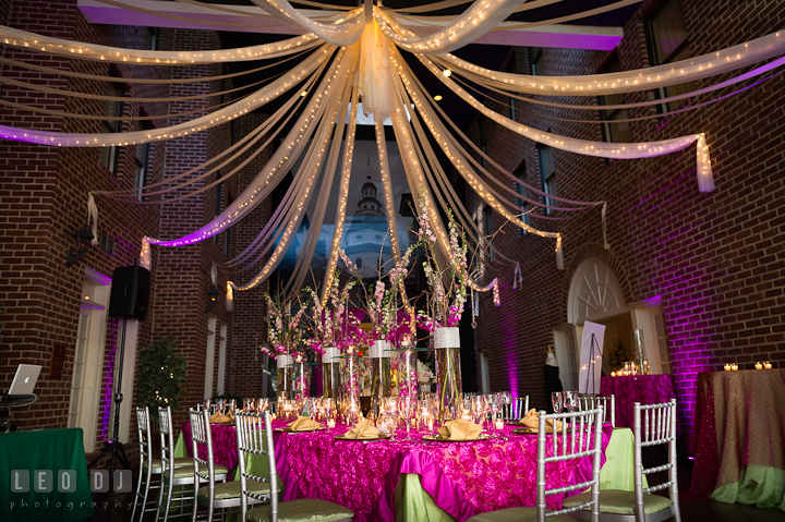 Table setup with tall vases centerpiece, and ceiling decoration with string of lights. Historic Inns of Annapolis wedding bridal fair photos at Calvert House by photographers of Leo Dj Photography. http://leodjphoto.com