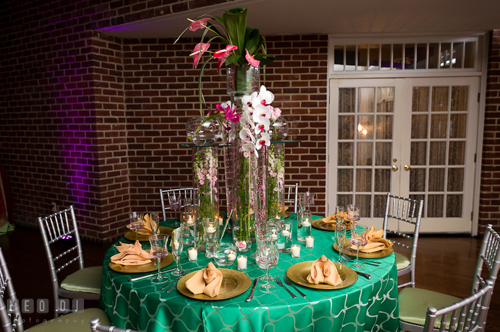 Table setup with tall centerpiece with white and purple orchids. Historic Inns of Annapolis wedding bridal fair photos at Calvert House by photographers of Leo Dj Photography. http://leodjphoto.com