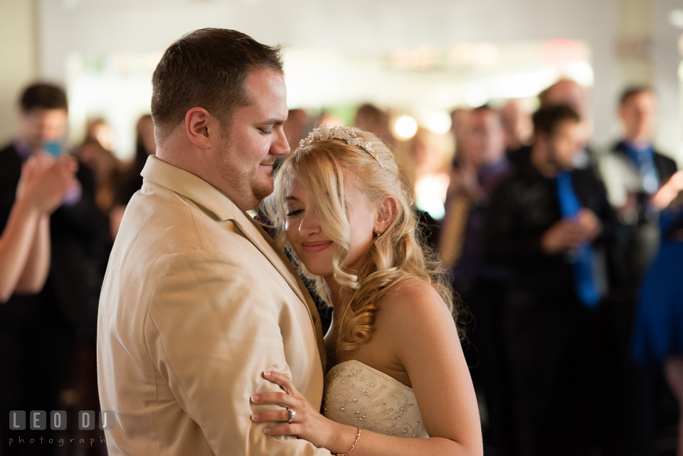 Bride and Groom embracing each other during their first dance as a married couple. Kent Island Maryland Chesapeake Bay Beach Club wedding photo, by wedding photographers of Leo Dj Photography. http://leodjphoto.com