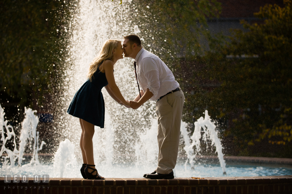 Engaged girl and his fiance kissing by the water fountain. Gettysburg PA pre-wedding engagement photo session, by wedding photographers of Leo Dj Photography. http://leodjphoto.com