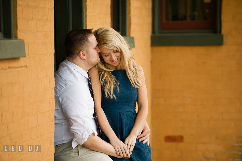 Engaged girl snuggled up with her fiance by the train station. Gettysburg PA pre-wedding engagement photo session, by wedding photographers of Leo Dj Photography. http://leodjphoto.com