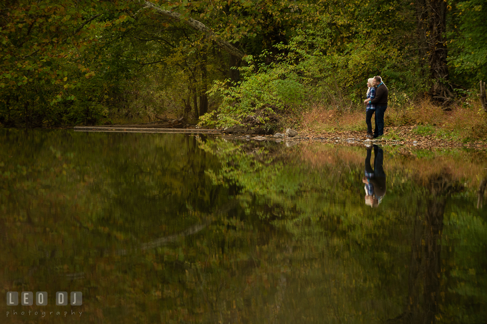 Engaged couple cuddling by the pond in the forest. Gettysburg PA pre-wedding engagement photo session, by wedding photographers of Leo Dj Photography. http://leodjphoto.com