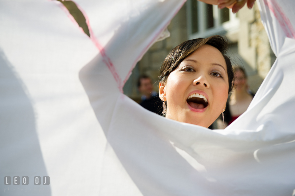 The Bride having fun during heart-cutting game on a sheet of fabric. Landgrafen Restaurant, Jena, Germany, wedding reception and ceremony photo, by wedding photographers of Leo Dj Photography. http://leodjphoto.com
