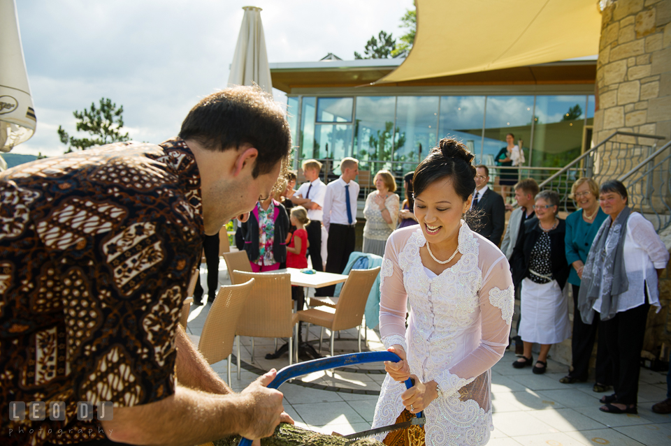 The Bride and Groom teamed up to cut the log with a bow saw. Landgrafen Restaurant, Jena, Germany, wedding reception and ceremony photo, by wedding photographers of Leo Dj Photography. http://leodjphoto.com