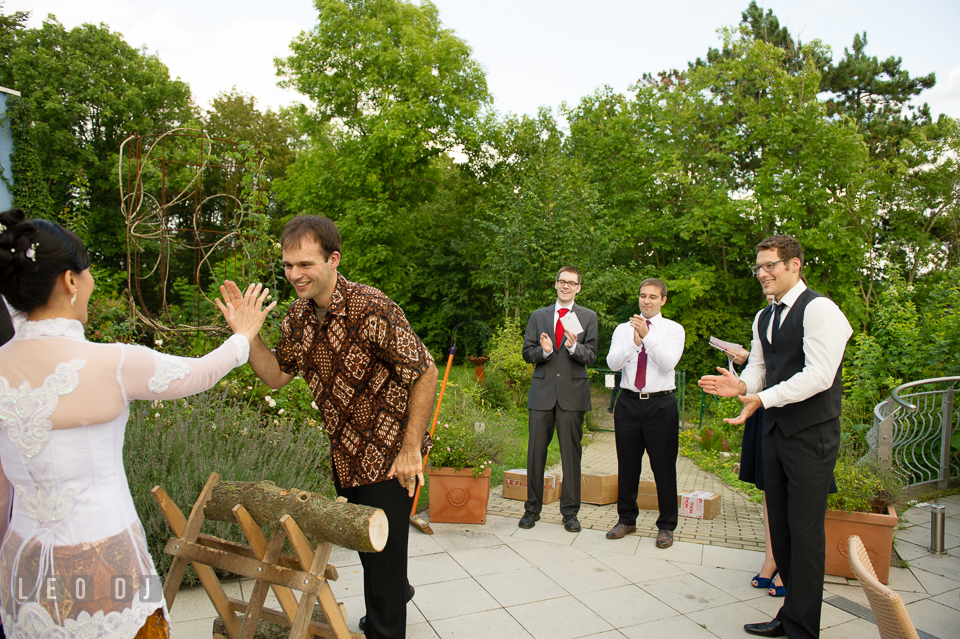 Bride and Groom cheered finished cutting the wooden log. Landgrafen Restaurant, Jena, Germany, wedding reception and ceremony photo, by wedding photographers of Leo Dj Photography. http://leodjphoto.com