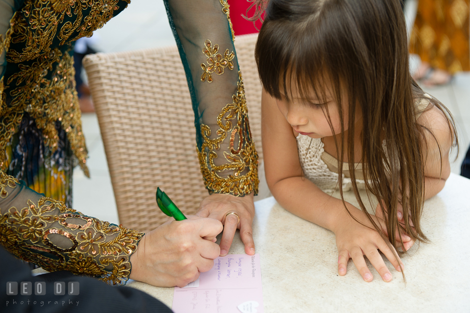 A young girl watching a guest wrote post card for the Bride and Groom. Landgrafen Restaurant, Jena, Germany, wedding reception and ceremony photo, by wedding photographers of Leo Dj Photography. http://leodjphoto.com