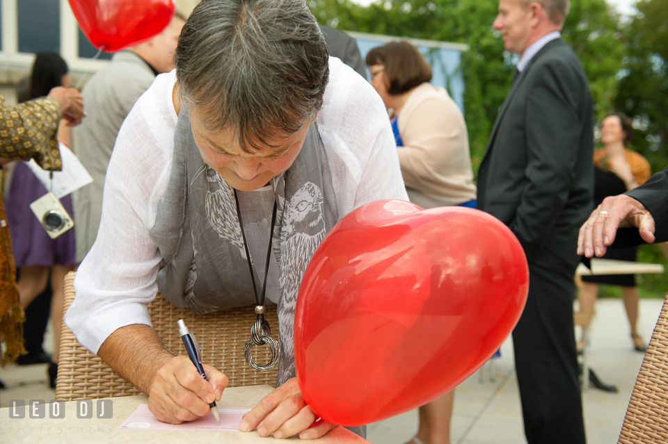 Mother of the Groom writing message on postcard for the newlywed couple. Landgrafen Restaurant, Jena, Germany, wedding reception and ceremony photo, by wedding photographers of Leo Dj Photography. http://leodjphoto.com