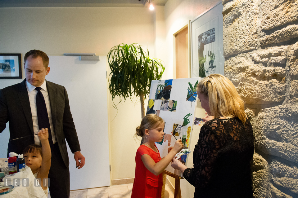 Guests painting on a canvas during the wedding reception. Landgrafen Restaurant, Jena, Germany, wedding reception and ceremony photo, by wedding photographers of Leo Dj Photography. http://leodjphoto.com