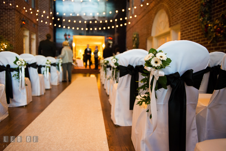 Chairs at ceremony site decorated with ribbons and flowers. Historic Inns of Annapolis, Governor Calvert House wedding Maryland, by wedding photographers of Leo Dj Photography. http://leodjphoto.com