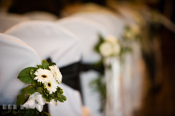 Close up shot of flower decoration for chairs at the ceremony site. Historic Inns of Annapolis, Governor Calvert House wedding Maryland, by wedding photographers of Leo Dj Photography. http://leodjphoto.com