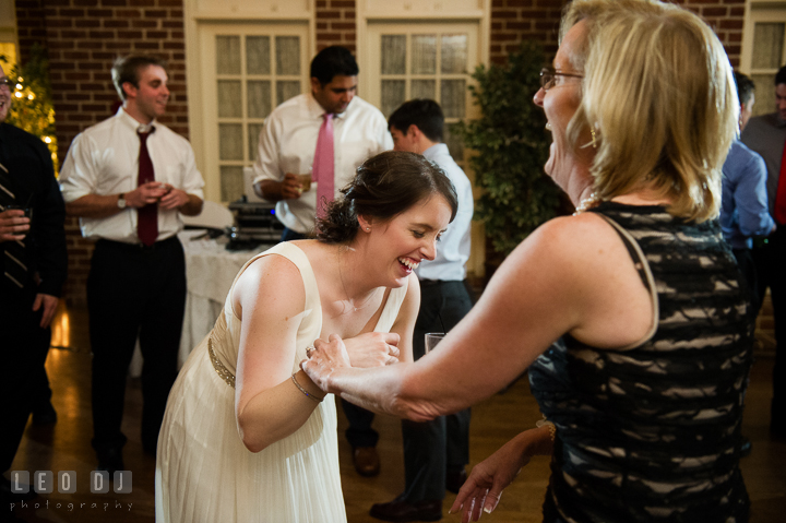 Bride laughing and dancing with Mother of Bride. Historic Inns of Annapolis, Governor Calvert House wedding Maryland, by wedding photographers of Leo Dj Photography. http://leodjphoto.com