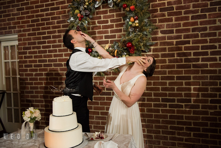 Bride and Groom smashing cakes to each other during the cake cutting. Historic Inns of Annapolis, Governor Calvert House wedding Maryland, by wedding photographers of Leo Dj Photography. http://leodjphoto.com