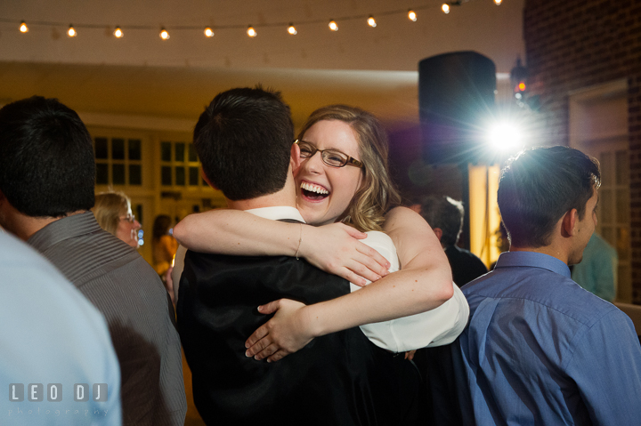 Bride's sister laughing and hugging her fiancé. Historic Inns of Annapolis, Governor Calvert House wedding Maryland, by wedding photographers of Leo Dj Photography. http://leodjphoto.com