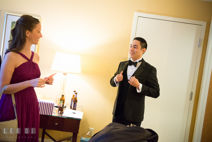 Groom talking to Maid of Honor receiving card and gift from Bride. Falls Church Virginia 2941 Restaurant wedding ceremony photo, by wedding photographers of Leo Dj Photography. http://leodjphoto.com