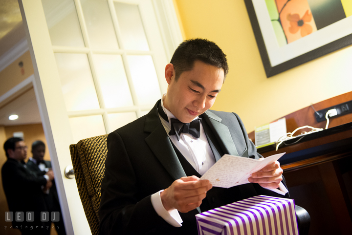 Groom opening and reading card from Bride. Falls Church Virginia 2941 Restaurant wedding ceremony photo, by wedding photographers of Leo Dj Photography. http://leodjphoto.com