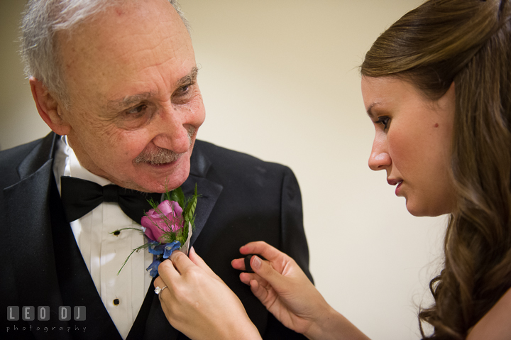 Bride's sister and Maid of Honor putting on boutonniere for Father. Falls Church Virginia 2941 Restaurant wedding ceremony photo, by wedding photographers of Leo Dj Photography. http://leodjphoto.com