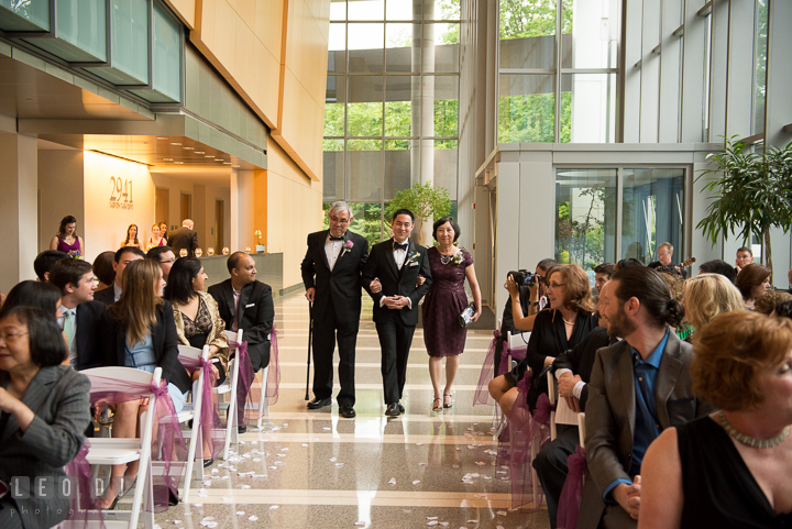 Groom walking down the isle during procession, escorted by Father and Mother of Groom. Falls Church Virginia 2941 Restaurant wedding ceremony photo, by wedding photographers of Leo Dj Photography. http://leodjphoto.com