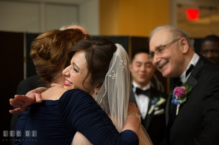 Mother of Bride hugging and giving away daughter. Falls Church Virginia 2941 Restaurant wedding ceremony photo, by wedding photographers of Leo Dj Photography. http://leodjphoto.com