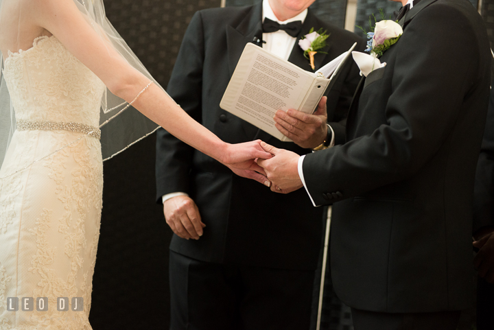 Bride and Groom holding hands during the ceremony. Falls Church Virginia 2941 Restaurant wedding ceremony photo, by wedding photographers of Leo Dj Photography. http://leodjphoto.com