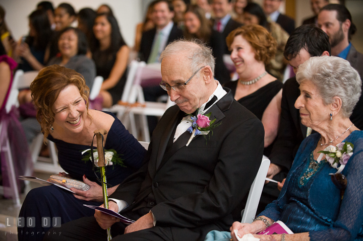 Parents and grandparents laughing listening to Bride and Groom's funny and sweet vows. Falls Church Virginia 2941 Restaurant wedding ceremony photo, by wedding photographers of Leo Dj Photography. http://leodjphoto.com