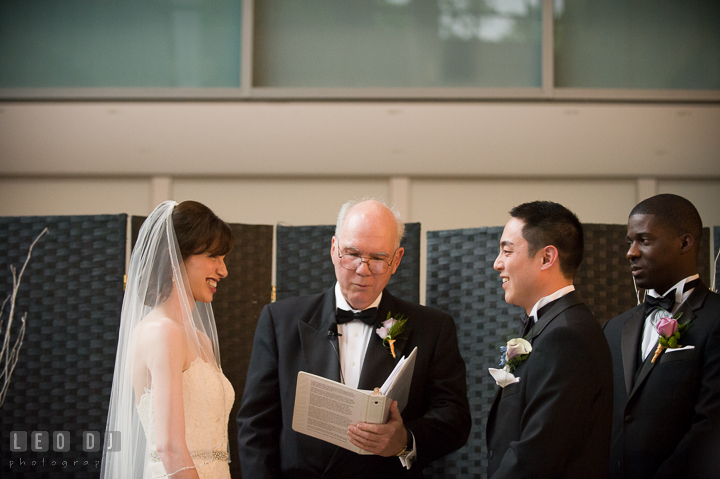 Bride and Groom smiling to each other during the ceremony. Falls Church Virginia 2941 Restaurant wedding ceremony photo, by wedding photographers of Leo Dj Photography. http://leodjphoto.com