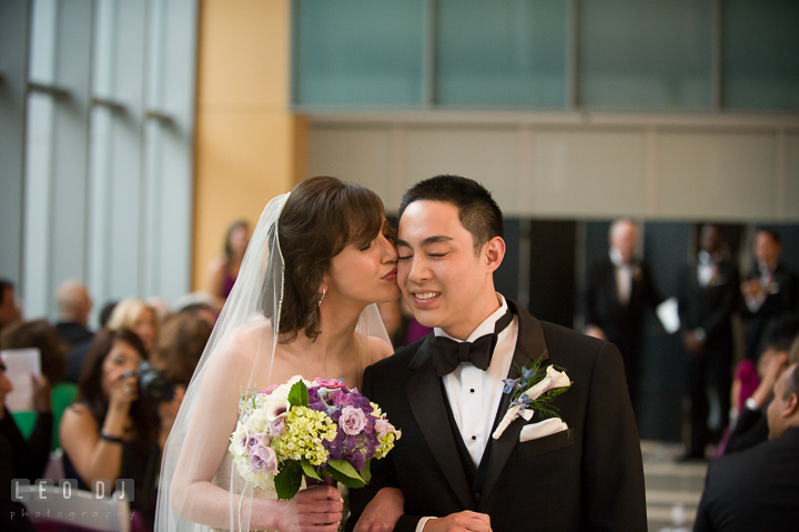 Bride kissed Groom's cheek while walking out of the aisle. Falls Church Virginia 2941 Restaurant wedding ceremony photo, by wedding photographers of Leo Dj Photography. http://leodjphoto.com