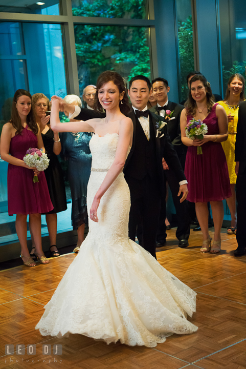 Groom twirl Bride while performing first dance observed by guests. Falls Church Virginia 2941 Restaurant wedding reception photo, by wedding photographers of Leo Dj Photography. http://leodjphoto.com