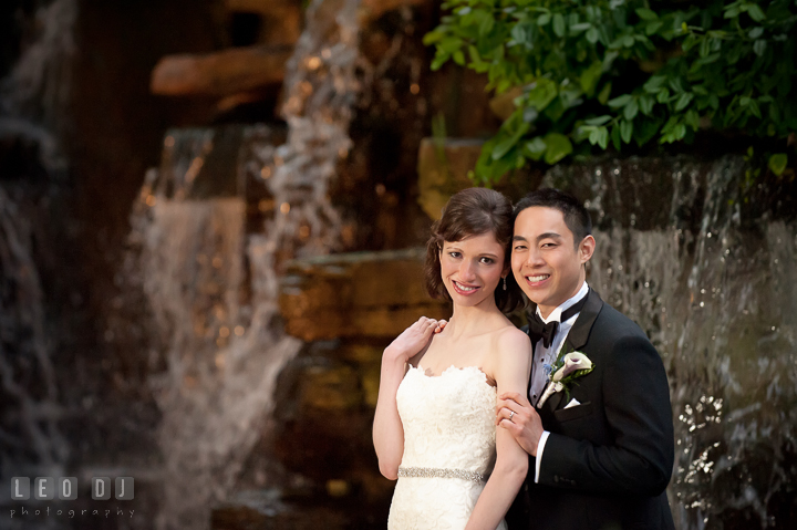 Bride and Groom smiling and posing by the waterfall. Falls Church Virginia 2941 Restaurant wedding reception photo, by wedding photographers of Leo Dj Photography. http://leodjphoto.com