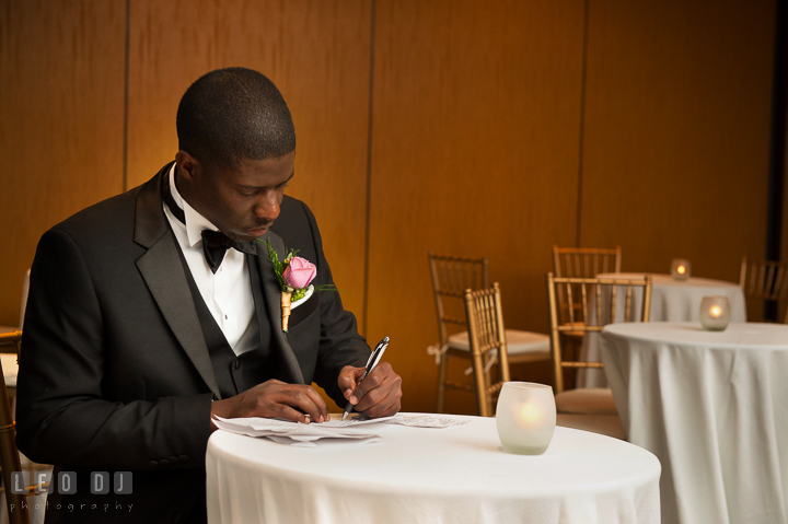 Best Man finishing up his speech notes. Falls Church Virginia 2941 Restaurant wedding reception photo, by wedding photographers of Leo Dj Photography. http://leodjphoto.com